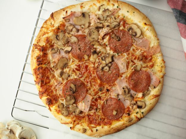 Pizza de jamón y queso con champiñones